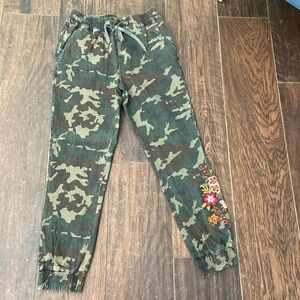 NWOT camouflage print with unique embroidery on bottom of left keg. Size small.